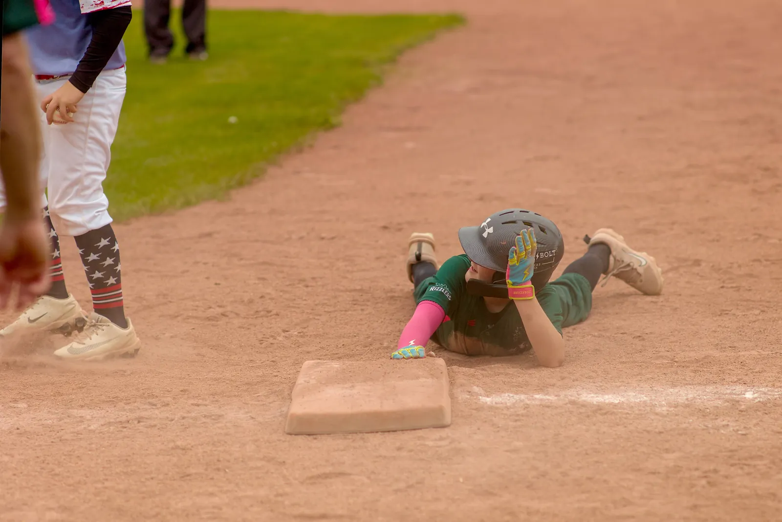 A Rizzlers player slides headfirst into base