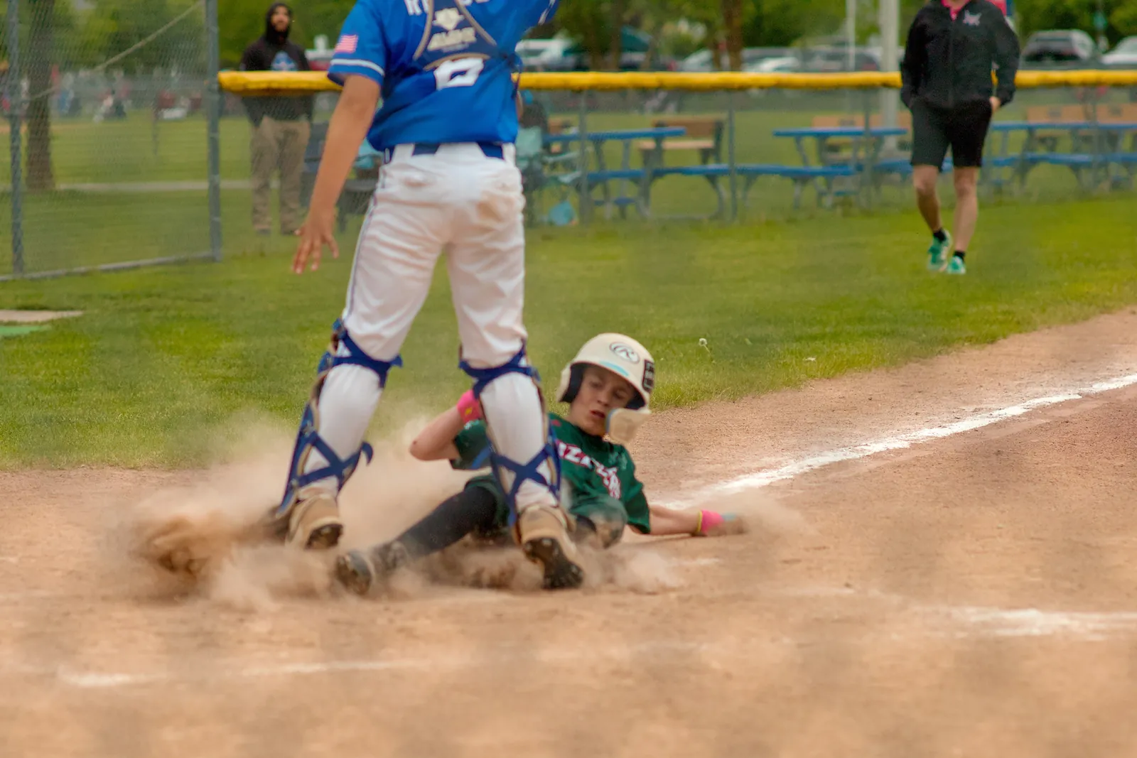 A Rizzlers runner slides into home plate