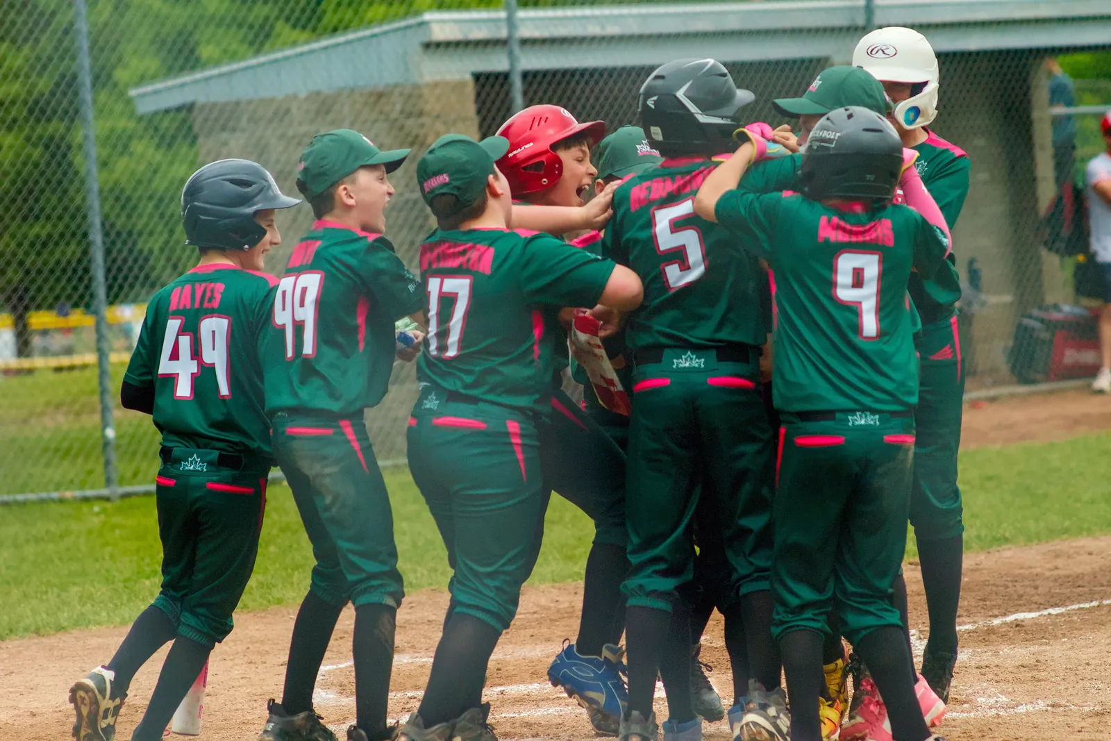 Rizzlers players mobbing a teammate after a big play