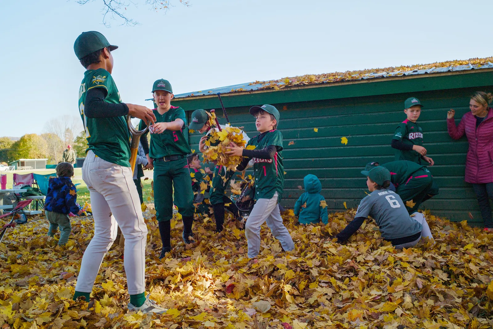 Rizzlers players throwing fall leaves in the air