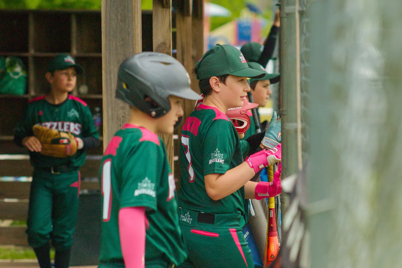 Rizzlers players waiting their turn in the dugout