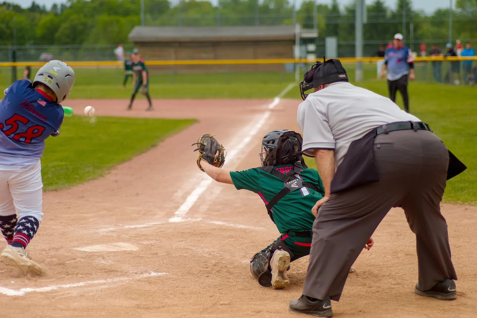 The Rizzlers catcher reaches for a pitch at home plate
