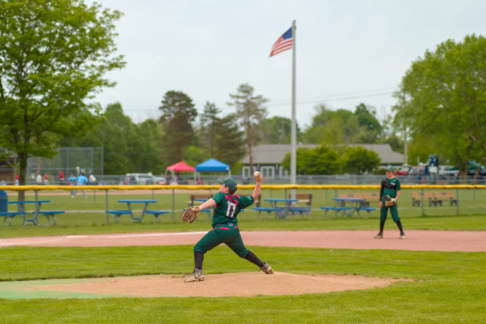 A Rizzlers pitcher throws with the flag flying behind