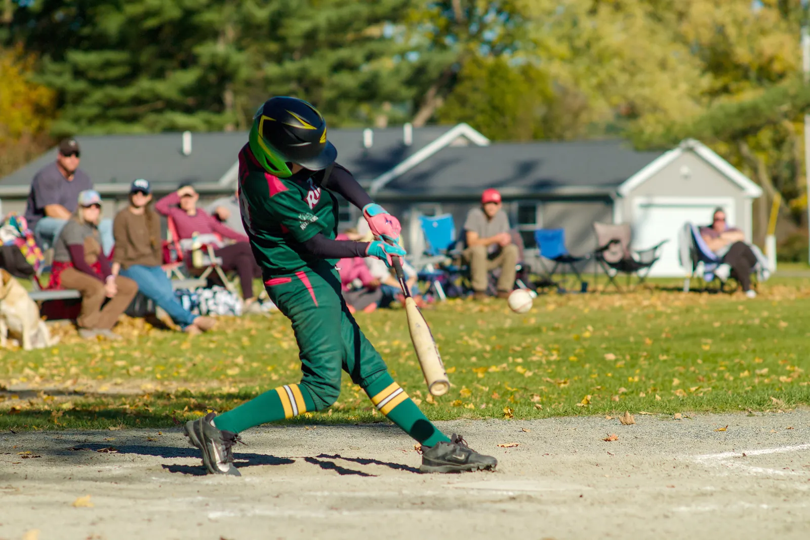 A Rizzlers batter swings at a pitch on a fall day