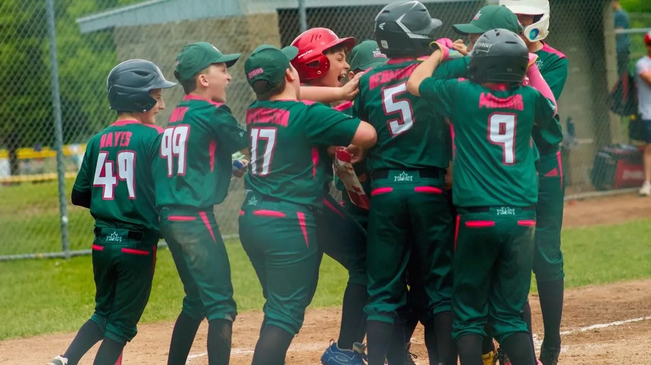 Rizzlers players celebrating at home plate